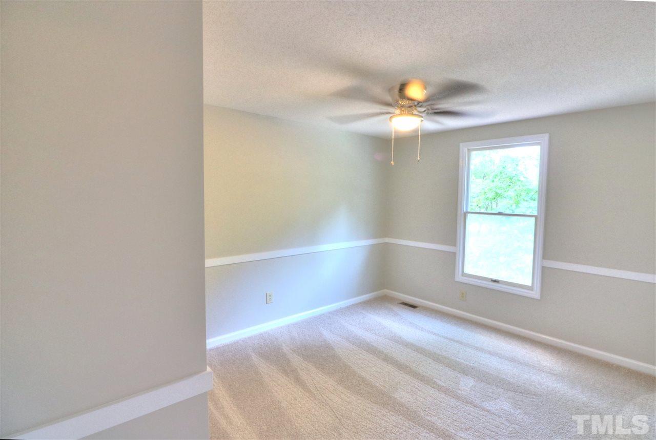 1909 Summerlyn Court Raleigh, NC 27609 - Photo 17 of 24 a view of room with window and ceiling fan