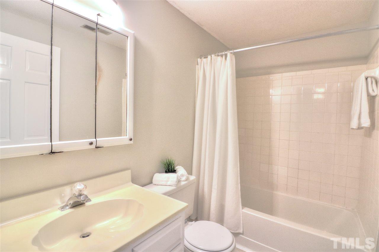 1909 Summerlyn Court Raleigh, NC 27609 - Photo 19 of 24 a bathroom with a sink toilet and shower