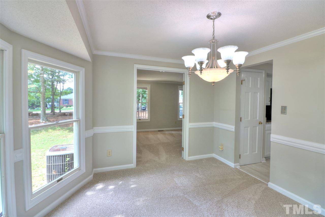 1909 Summerlyn Court Raleigh, NC 27609 - Photo 4 of 24 a view of a chandelier in big room with windows and chandelier