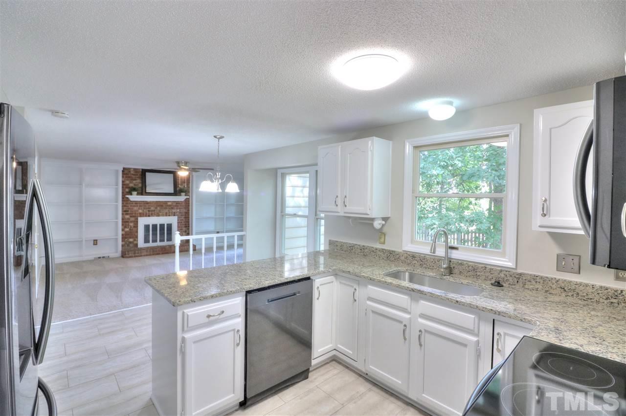 1909 Summerlyn Court Raleigh, NC 27609 - Photo 6 of 24 a kitchen with stainless steel appliances granite countertop a sink stove and refrigerator