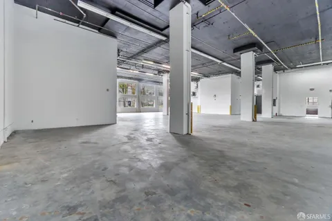 a view of water heater room with wooden floor