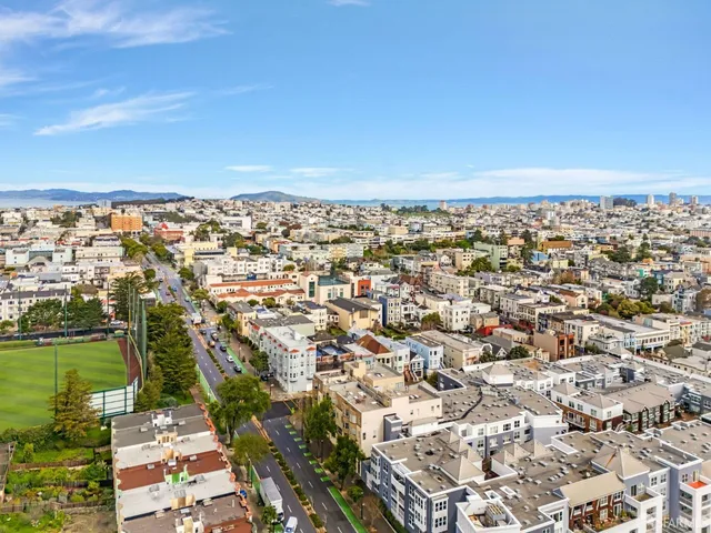 a view of a livingroom with a fireplace and window