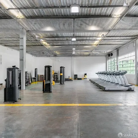 a view of gym area with gym equipment and floor to ceiling window