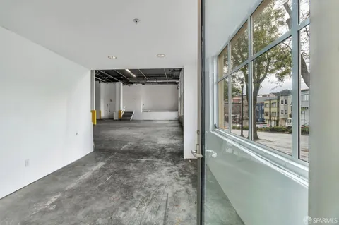 a view of a big room with wooden floor and door
