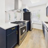 a kitchen with stainless steel appliances granite countertop a stove and a refrigerator