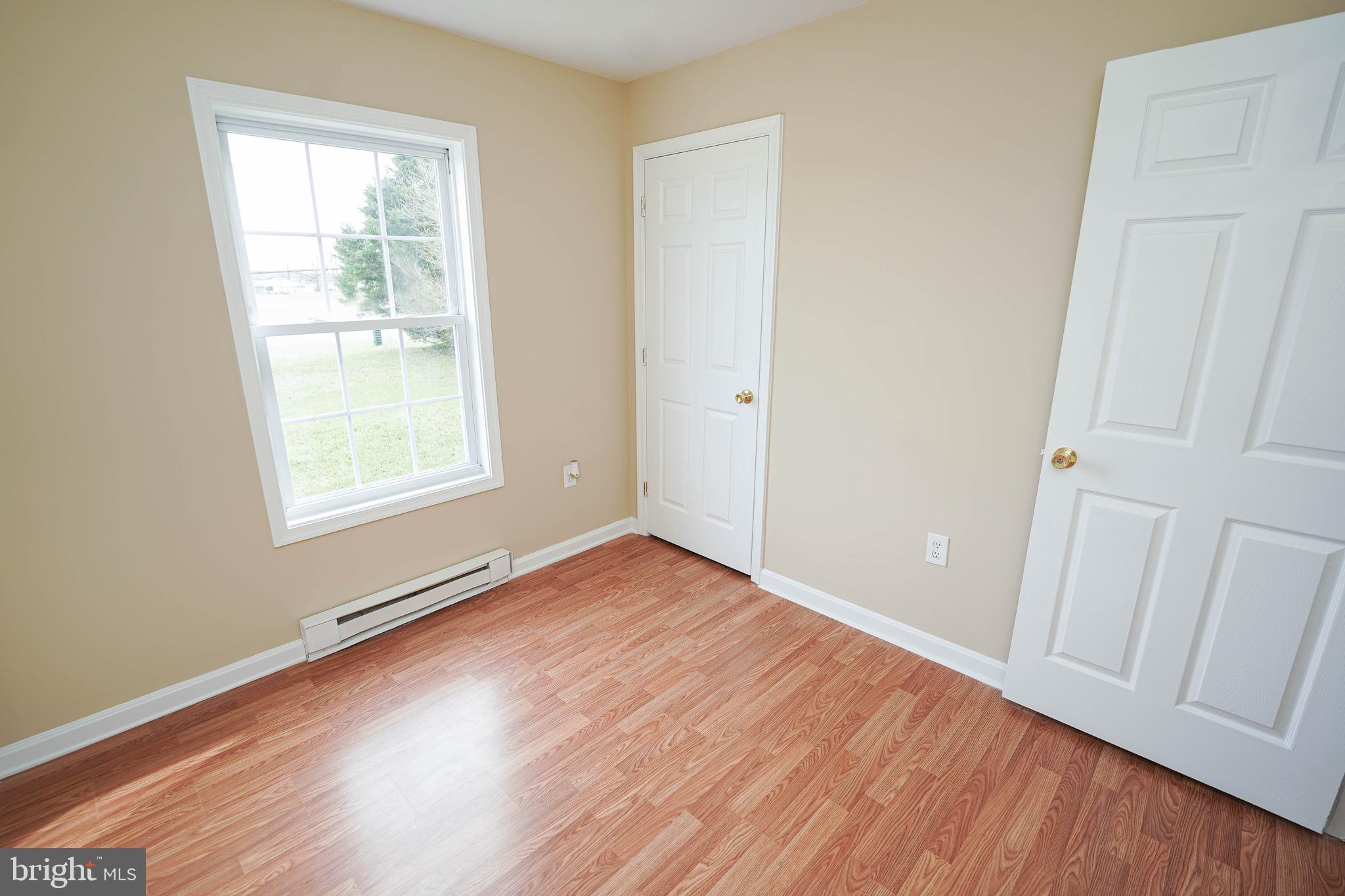 7526 Bethel Road Willards, MD 21874 - Photo 23 of 34 an empty room with wooden floor and windows
