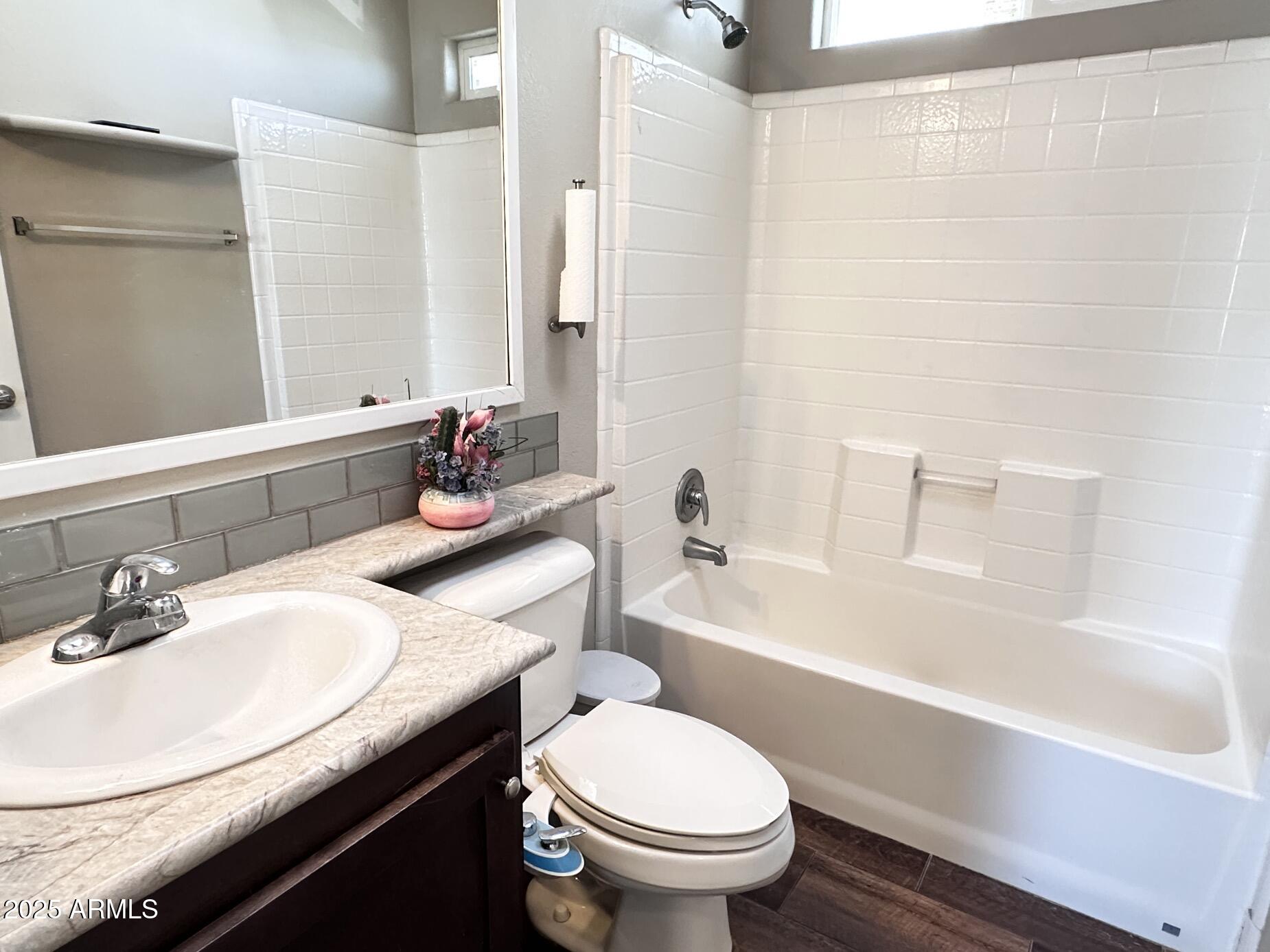 2000 South Apache Road, Unit 126 Buckeye, AZ 85326 - Photo 12 of 29 a bathroom with a sink toilet vanity and bathtub
