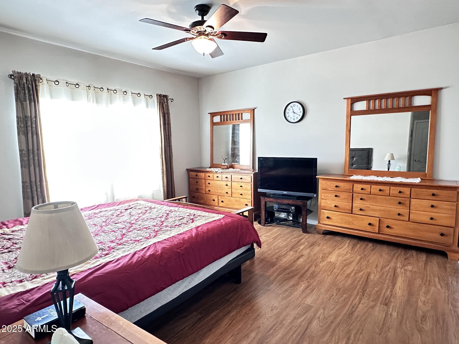 2000 South Apache Road, Unit 126 Buckeye, AZ 85326 - Photo 14 of 29 a bedroom with a bed and wooden floor