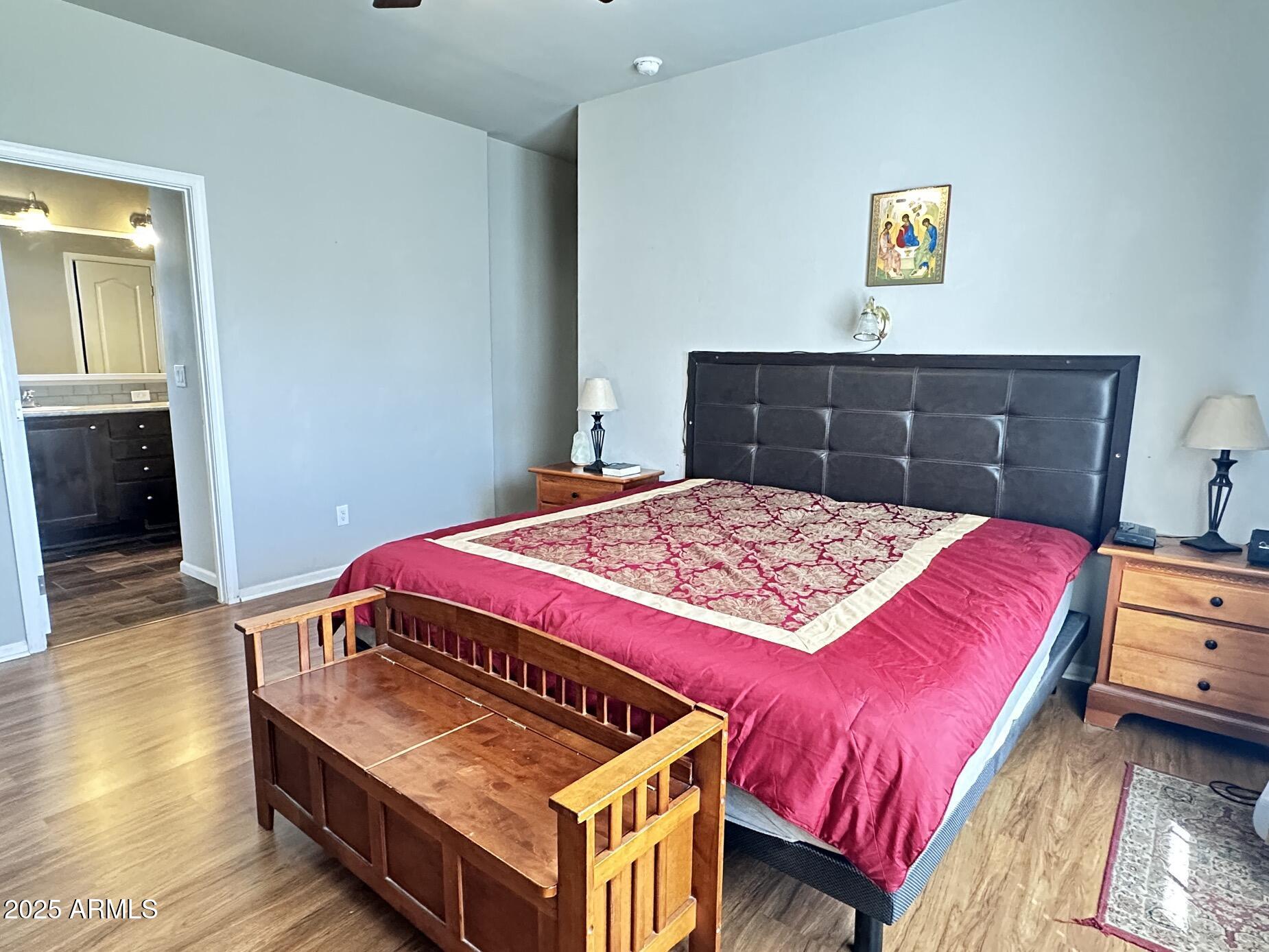 2000 South Apache Road, Unit 126 Buckeye, AZ 85326 - Photo 16 of 29 a bedroom with a bed and wooden floor