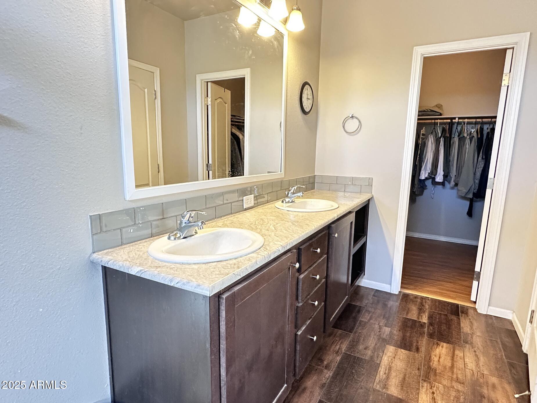 2000 South Apache Road, Unit 126 Buckeye, AZ 85326 - Photo 17 of 29 a bathroom with a sink double vanity granite tub shower and a mirror