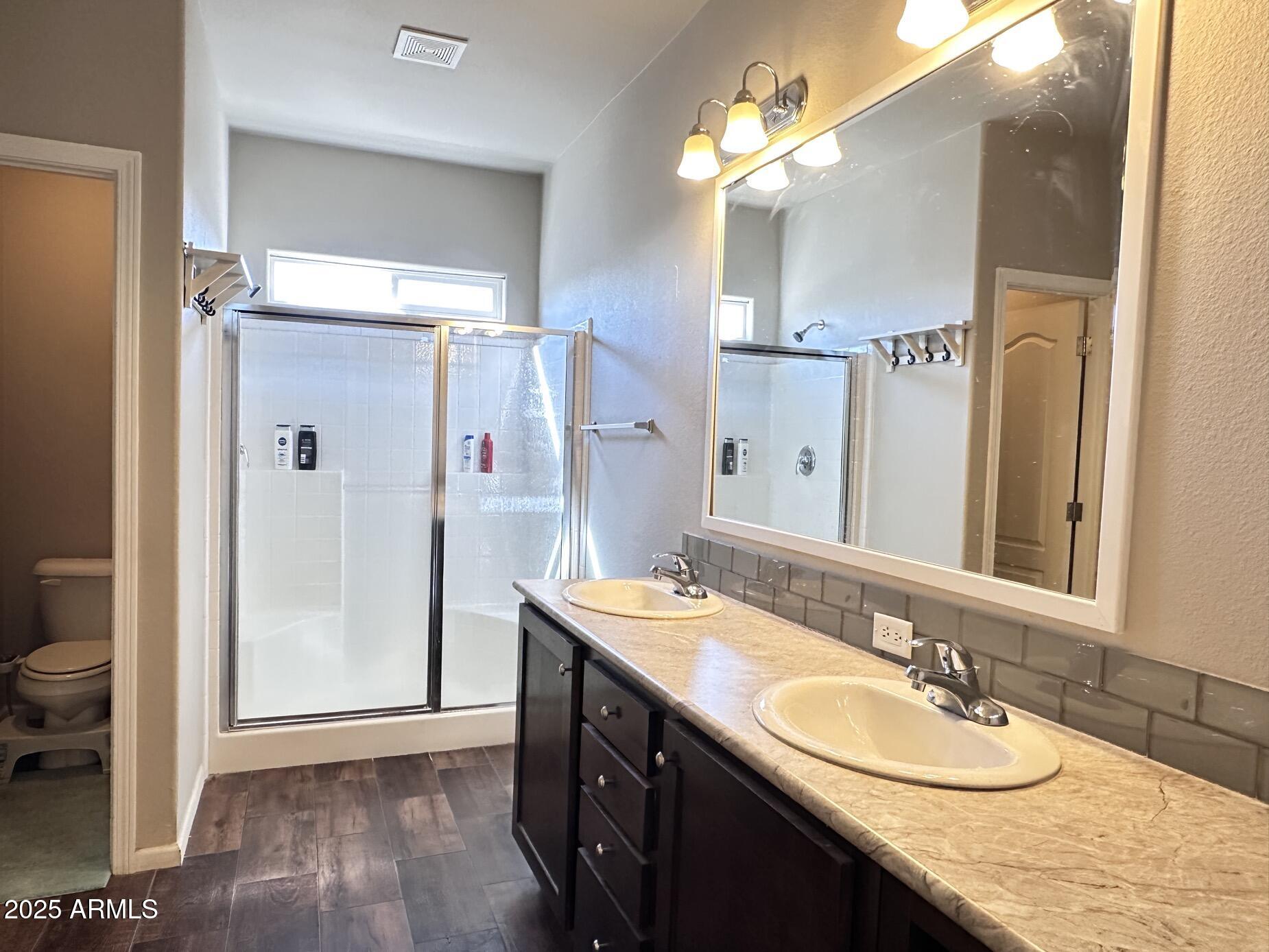 2000 South Apache Road, Unit 126 Buckeye, AZ 85326 - Photo 18 of 29 a bathroom with a granite countertop sink shower and a mirror
