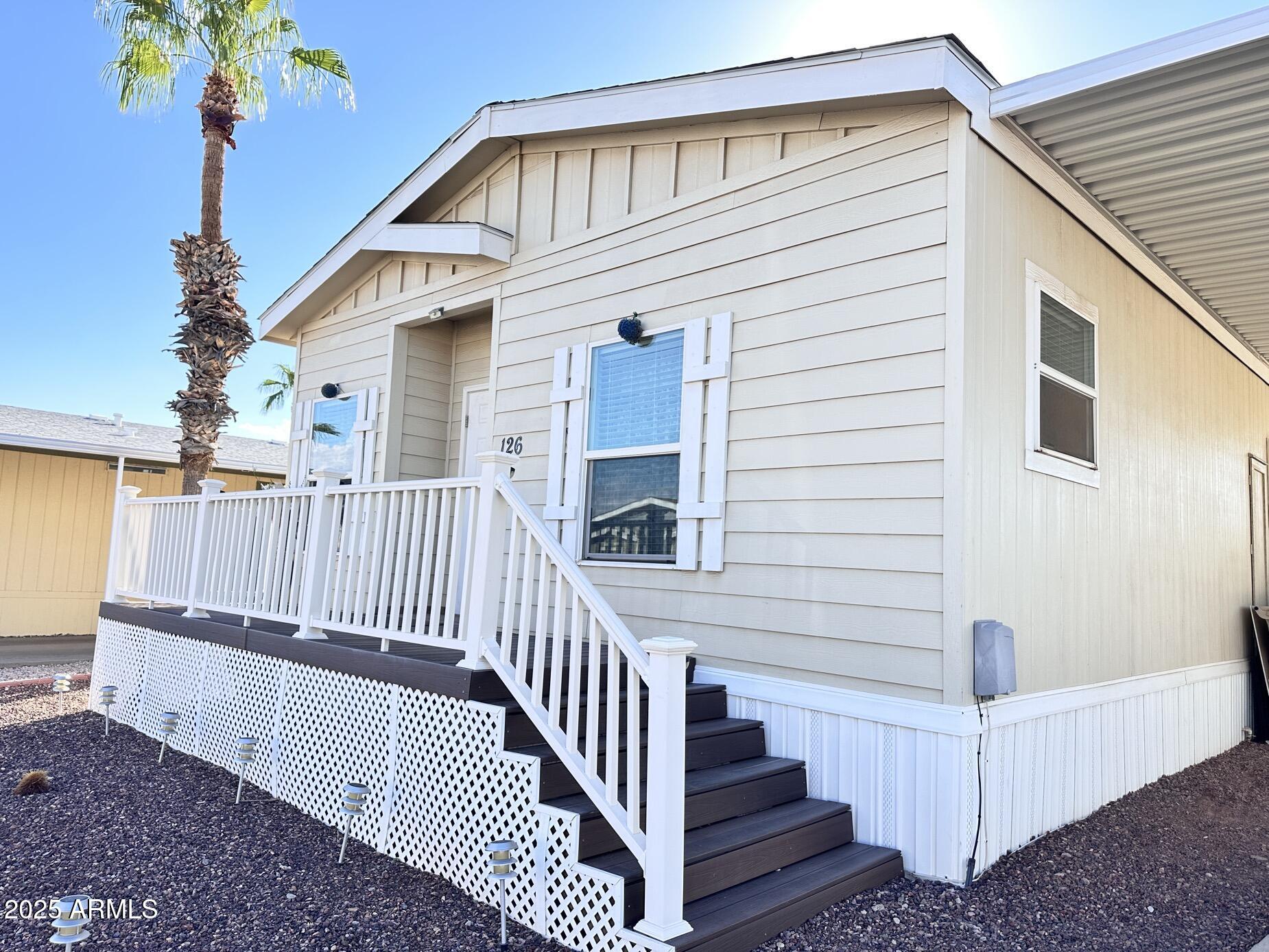 2000 South Apache Road, Unit 126 Buckeye, AZ 85326 - Photo 2 of 29 a view of a house with wooden floor and fence