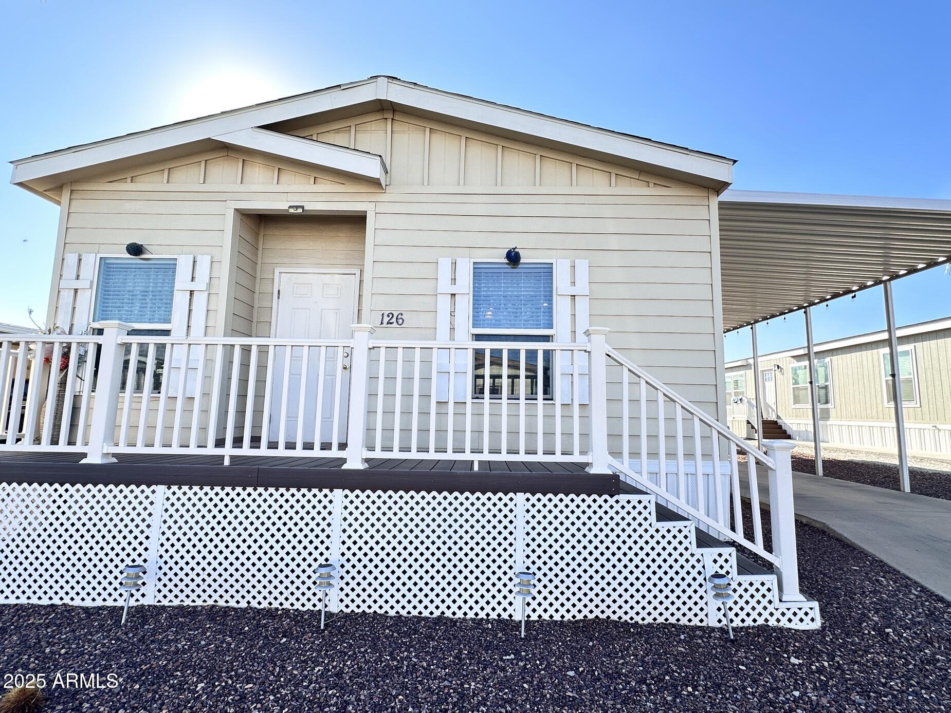 2000 South Apache Road, Unit 126 Buckeye, AZ 85326 - Photo 3 of 29 a front view of a house with a fence