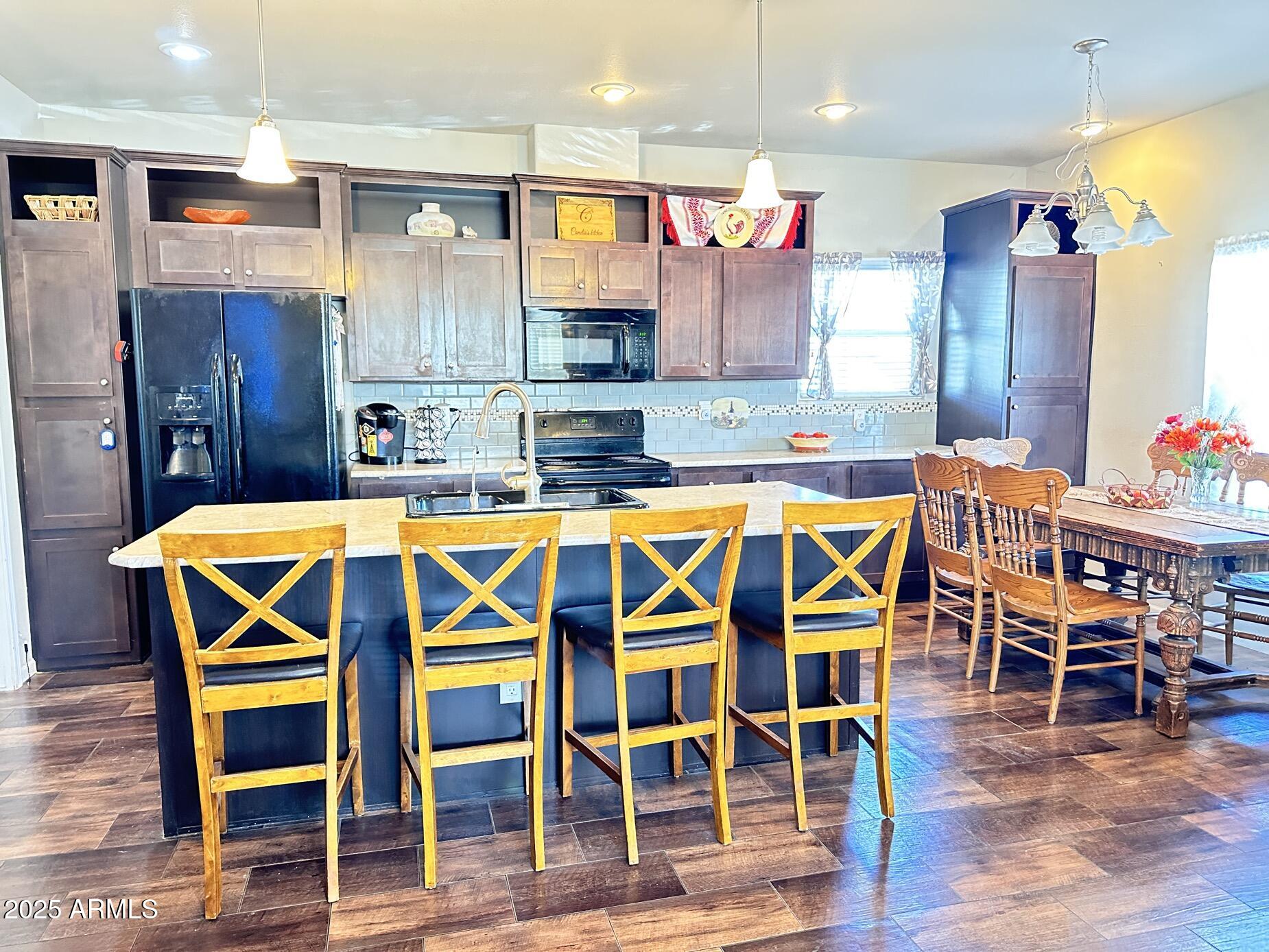 2000 South Apache Road, Unit 126 Buckeye, AZ 85326 - Photo 8 of 29 a dining table with chairs and wooden floor