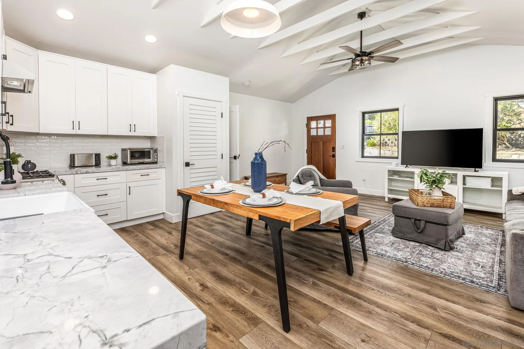 2335 Ivy Road Oceanside, CA 92054 - Photo 43 of 53 a living room with stainless steel appliances kitchen island granite countertop furniture a rug and a kitchen view
