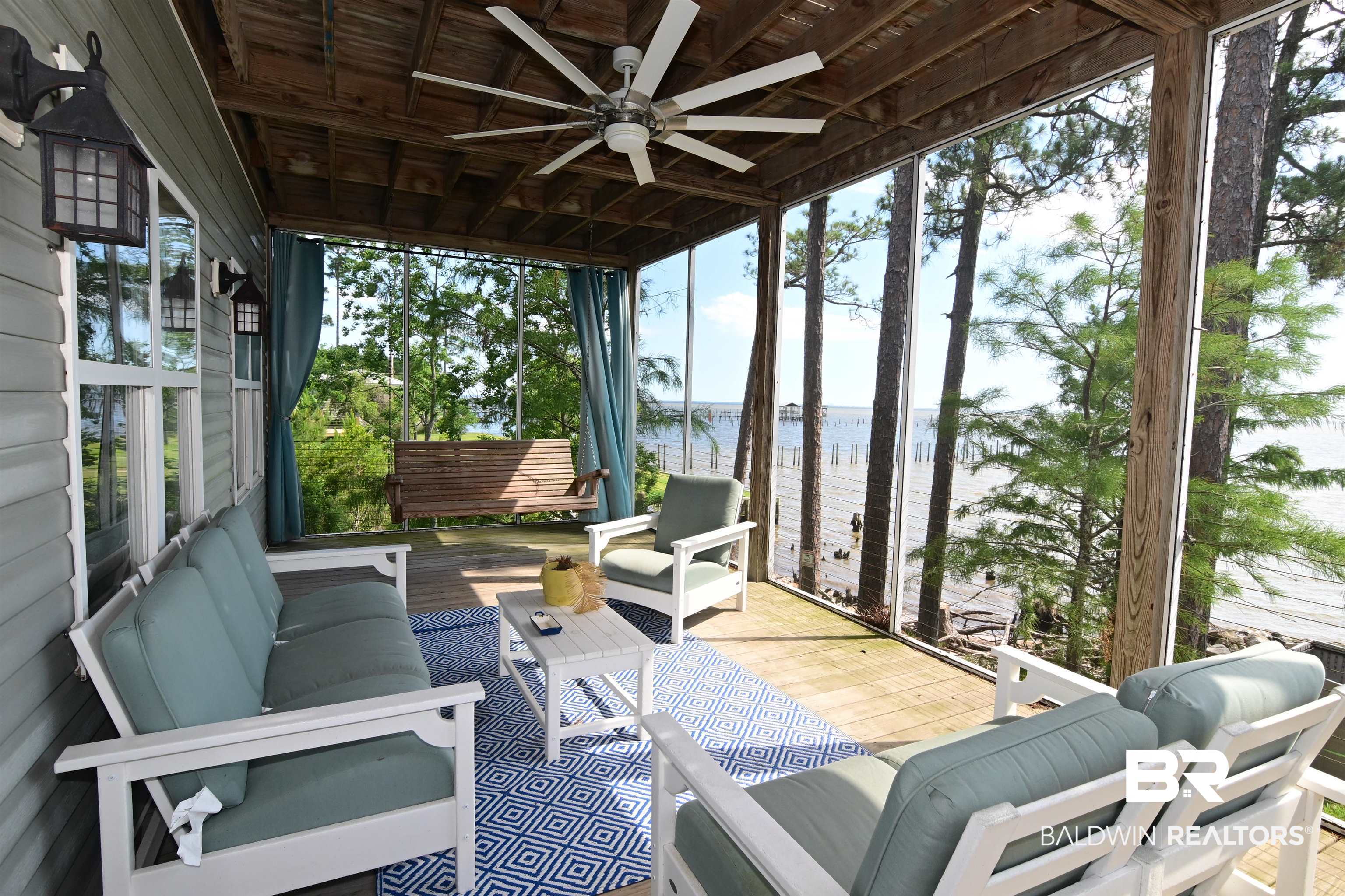 9397 South Bay Street Foley, AL 36535 - Photo 4 of 57 Unit 1's screened porch with space to relax along with a ceiling fan and view of the Bay