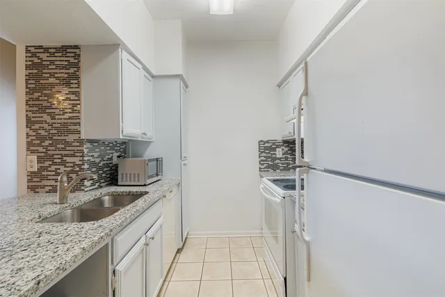 a kitchen with a sink stove and refrigerator