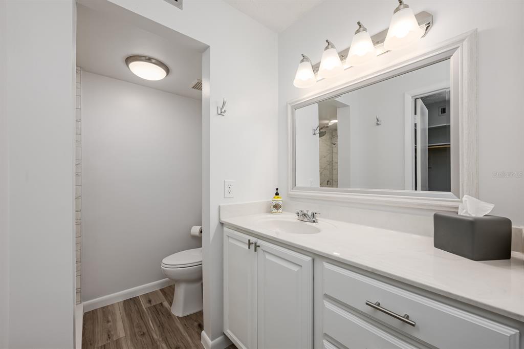 4224 Lake Underhill Road, Unit 8B5 Orlando, FL 32803 - Photo 14 of 40 a bathroom with a sink a toilet and mirror
