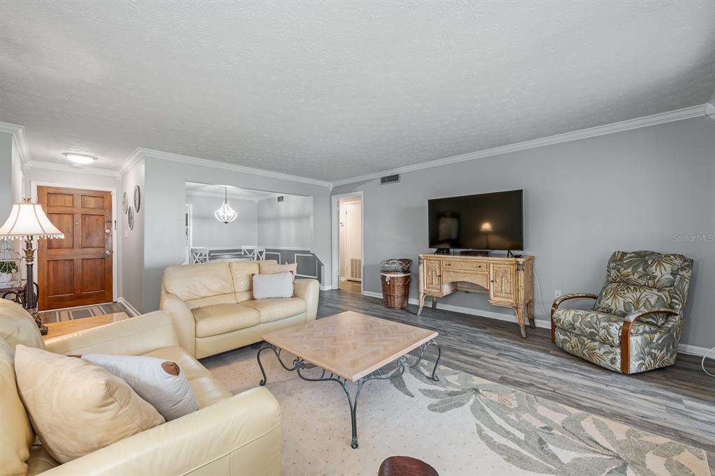 4224 Lake Underhill Road, Unit 8B5 Orlando, FL 32803 - Photo 3 of 40 a living room with furniture and a flat screen tv