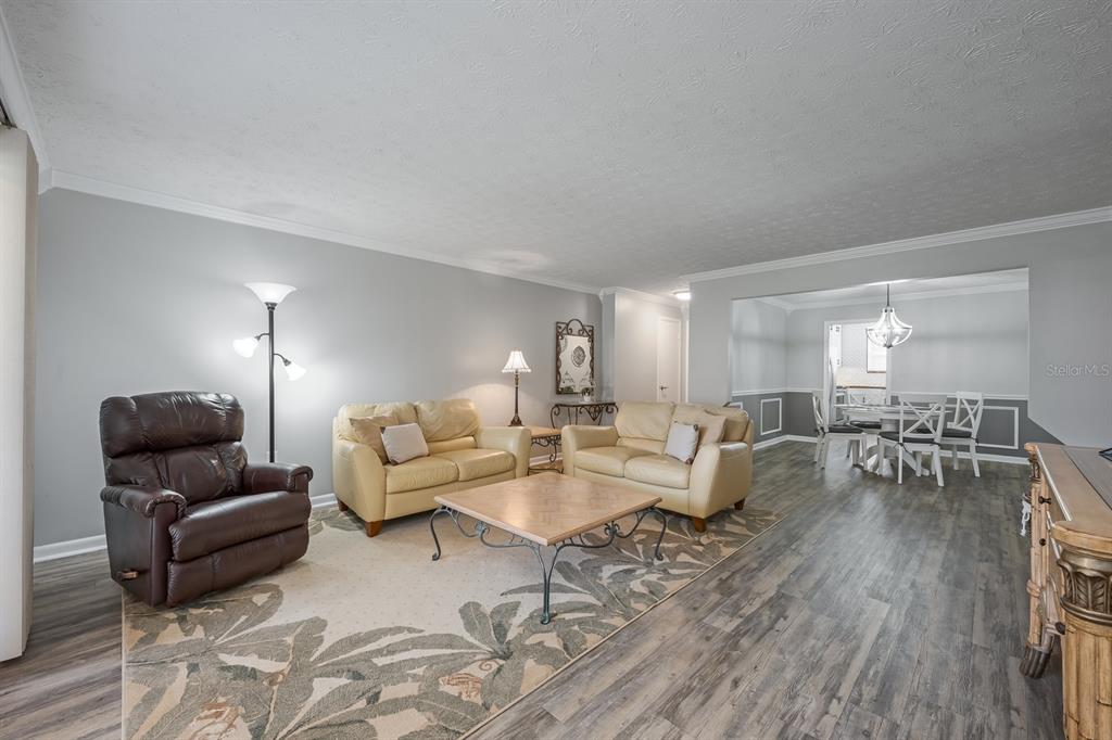 4224 Lake Underhill Road, Unit 8B5 Orlando, FL 32803 - Photo 5 of 40 a living room with furniture and wooden floor