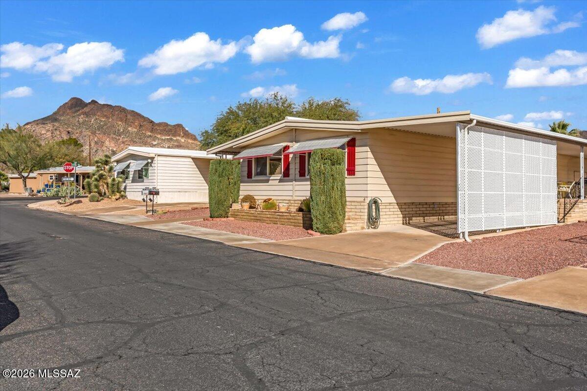 5840 West Flying W Street Tucson, AZ 85713 - Photo 3 of 38 a front view of a house with a yard
