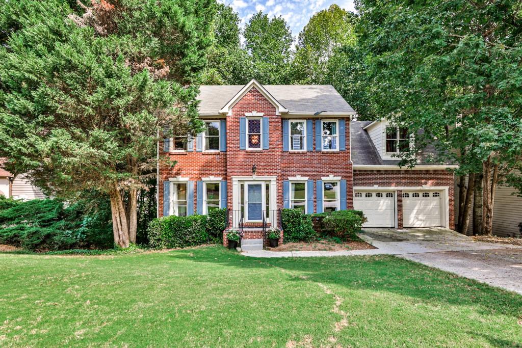 11625 Windbrooke Way Alpharetta, GA 30005 - Photo 1 of 1 a front view of a house with a yard and potted plants