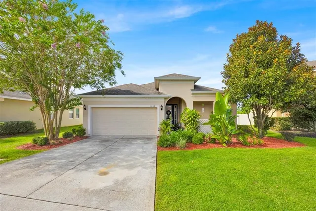a front view of a house with a yard and garage