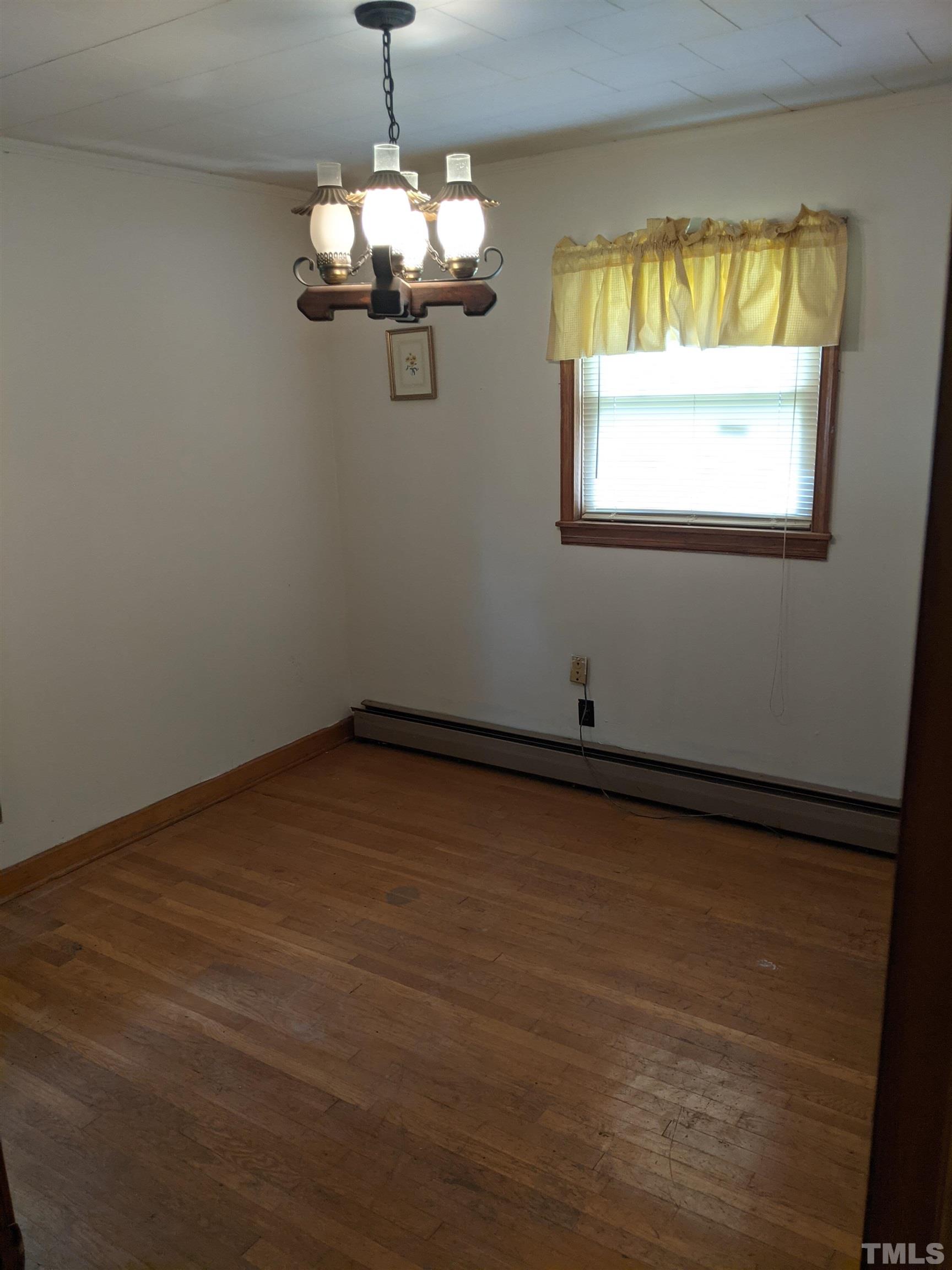 102 Dee Long Road Roxboro, NC 27574 - Photo 12 of 21 a view of a room with wooden floor and chandelier