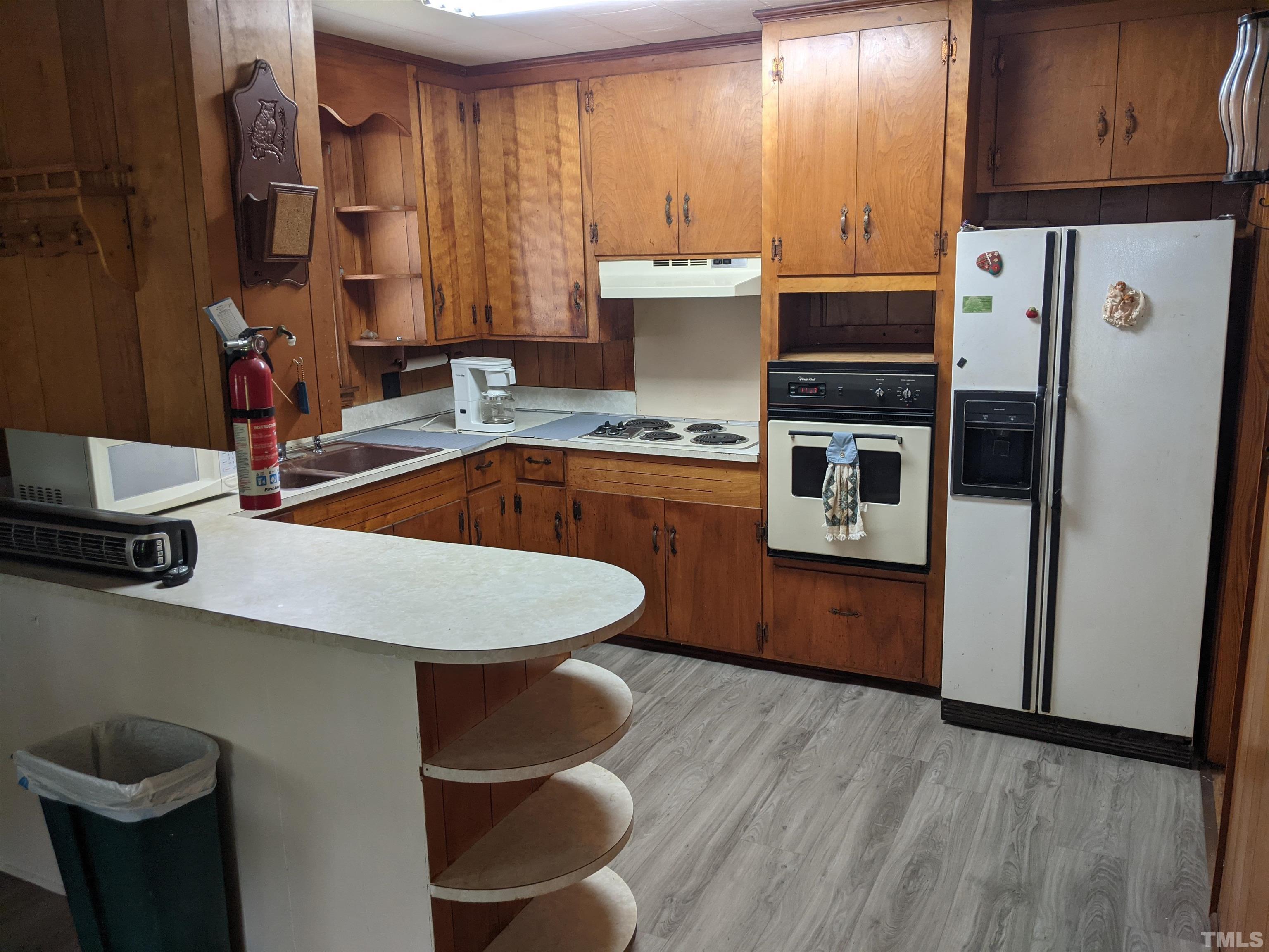 102 Dee Long Road Roxboro, NC 27574 - Photo 9 of 21 a kitchen with stainless steel appliances a sink a stove a refrigerator and cabinets