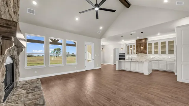 a large kitchen with stainless steel appliances kitchen island wooden floors and center island