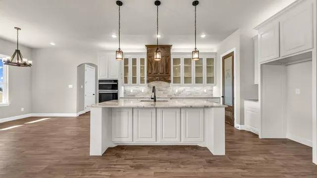 a view of kitchen with granite countertop cabinets and wooden floor