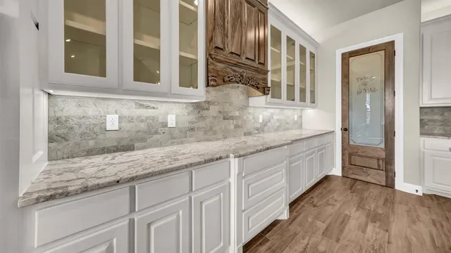 a bathroom with a granite countertop double vanity sink and mirror