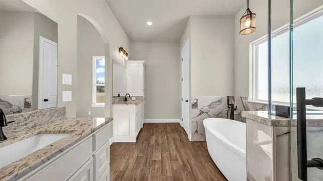 a spacious bathroom with sink shower and a mirror