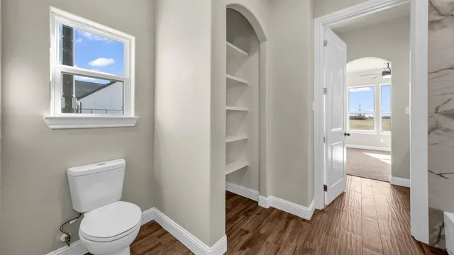 a white toilet sitting next to a bathroom sink