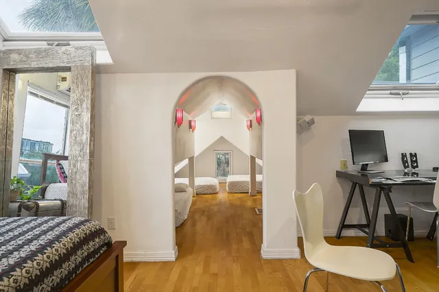 a bedroom with a bed and a chandelier