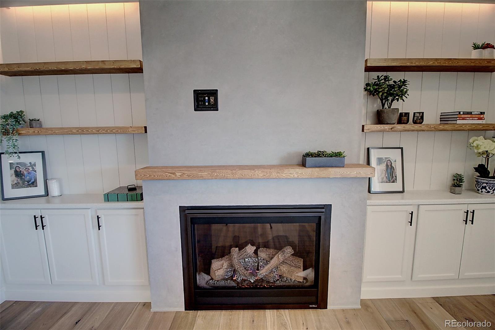 1013 Gabriella Lane Berthoud, CO 80513 - Photo 12 of 39 a hallway with a fireplace and cabinets