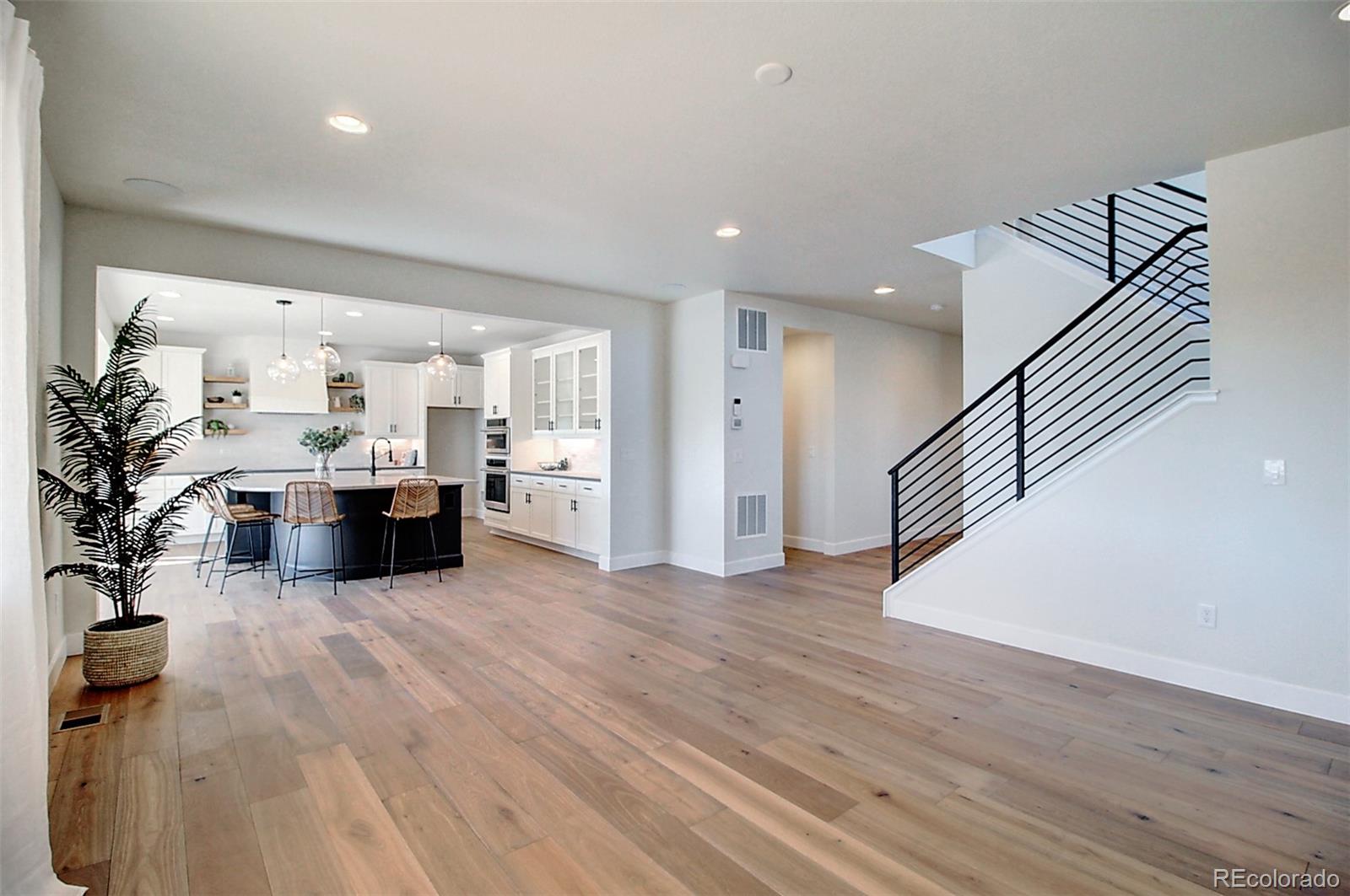 1013 Gabriella Lane Berthoud, CO 80513 - Photo 14 of 39 a view of a living room kitchen with furniture and wooden floor