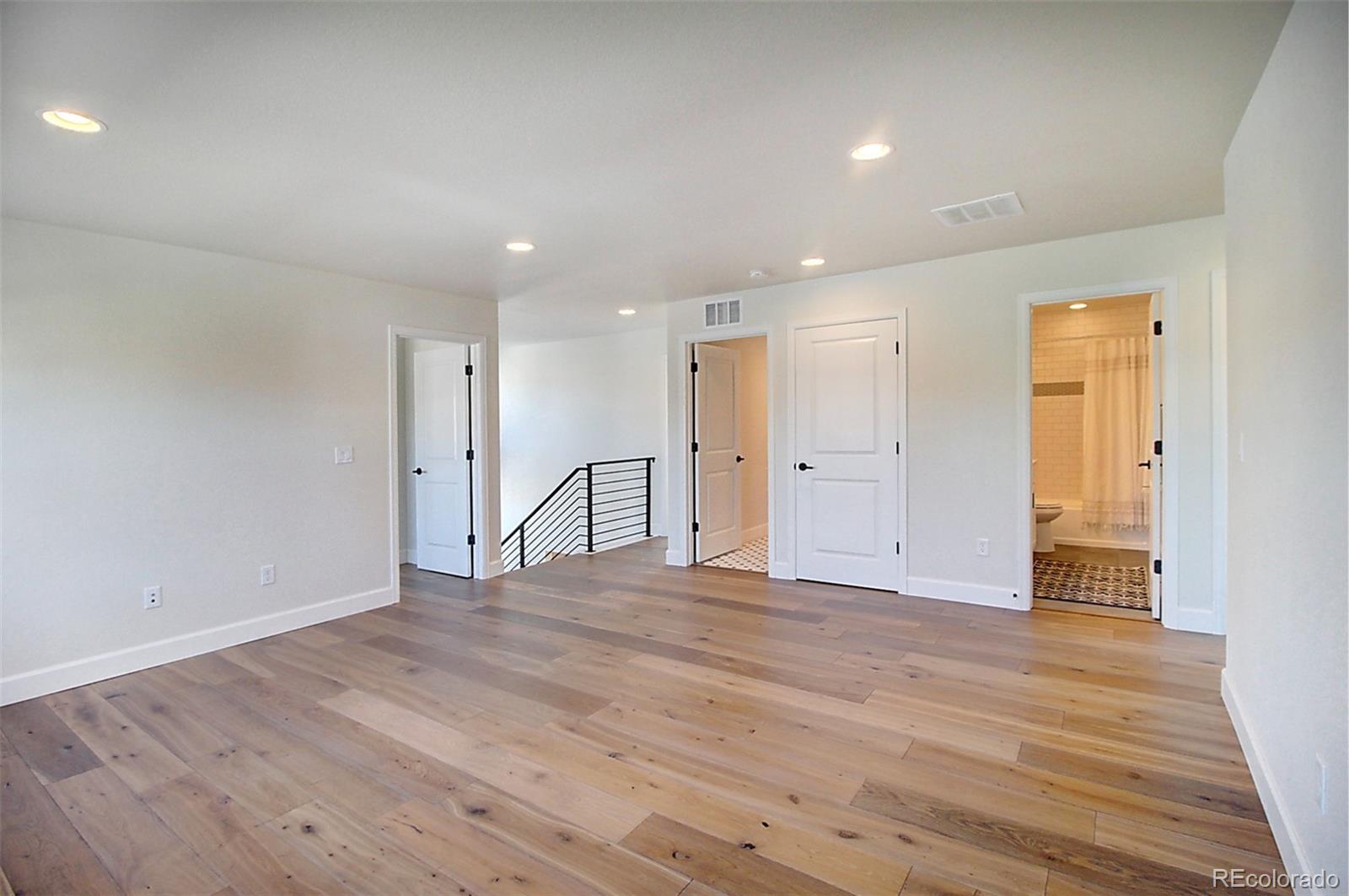 1013 Gabriella Lane Berthoud, CO 80513 - Photo 18 of 39 a view of an empty room with wooden floor