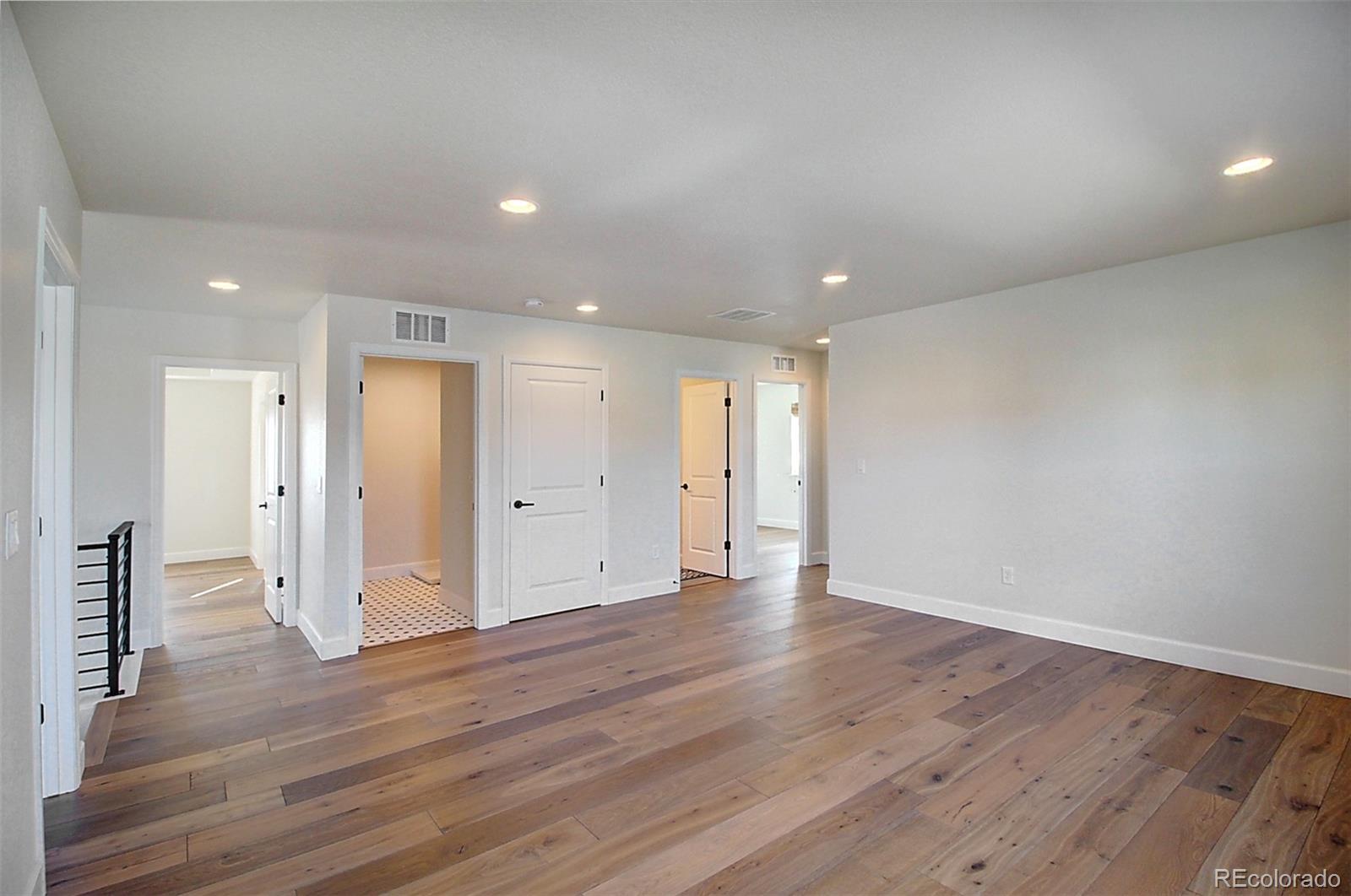 1013 Gabriella Lane Berthoud, CO 80513 - Photo 19 of 39 a view of an empty room with wooden floor and closet