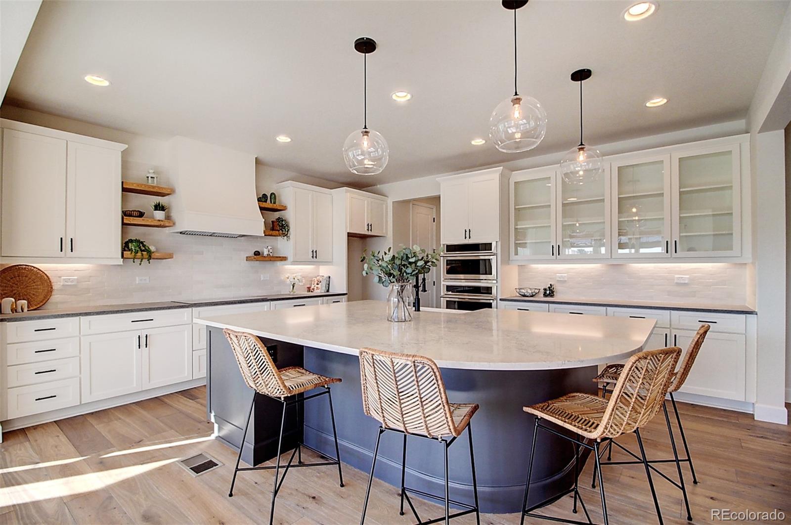 1013 Gabriella Lane Berthoud, CO 80513 - Photo 3 of 39 a kitchen with stainless steel appliances a dining table chairs and white cabinets
