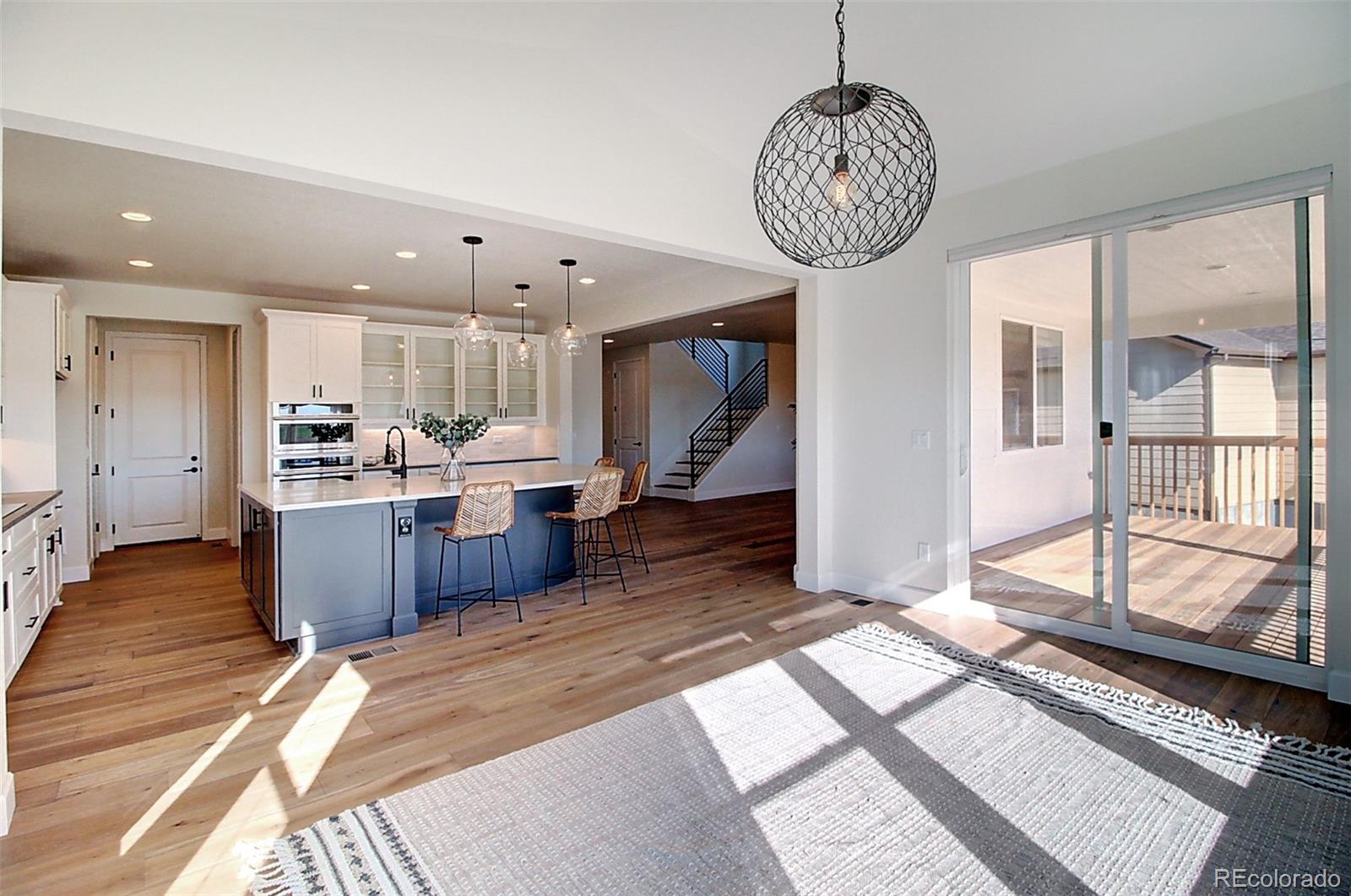 1013 Gabriella Lane Berthoud, CO 80513 - Photo 4 of 39 a view of a kitchen with kitchen island stainless steel appliances counter space a sink and a chandelier