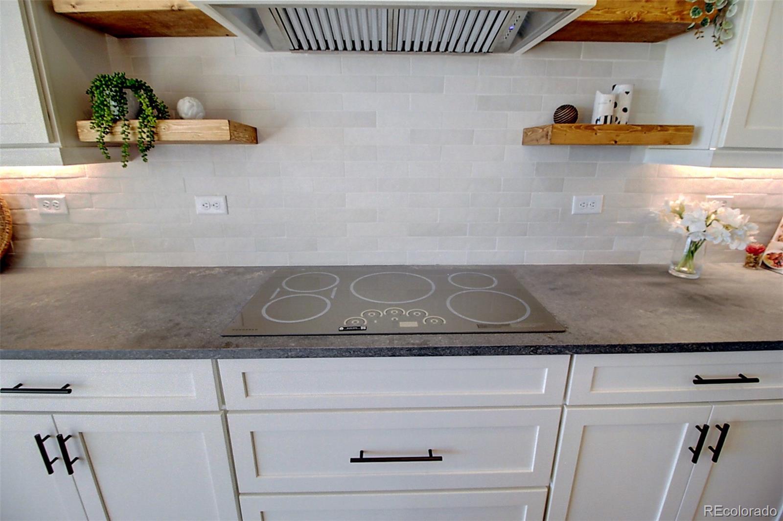 1013 Gabriella Lane Berthoud, CO 80513 - Photo 5 of 39 a close view of dining table cabinets and a potted plant on a counter
