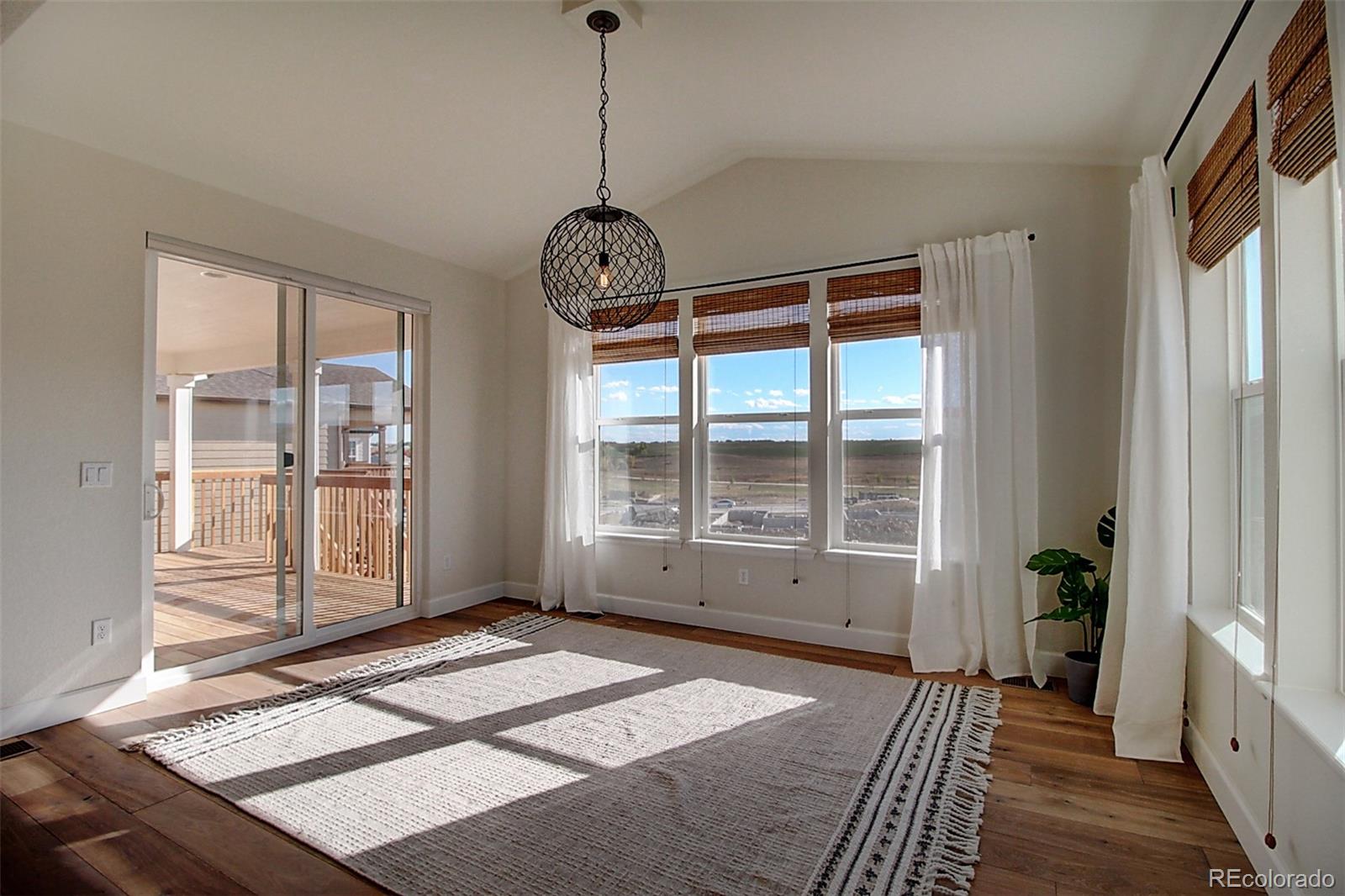 1013 Gabriella Lane Berthoud, CO 80513 - Photo 8 of 39 a view of a room with wooden floor and windows
