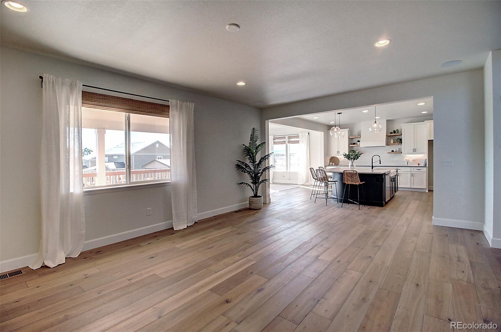 1013 Gabriella Lane Berthoud, CO 80513 - Photo 10 of 39 a living room with furniture and large windows