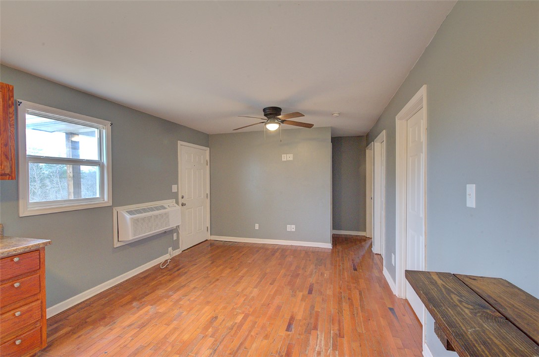 325 Rock Quarry Road Travelers Rest, SC 29690 - Photo 8 of 37 This inviting space features hardwood floors and a ceiling fan, creating a comfortable atmosphere.