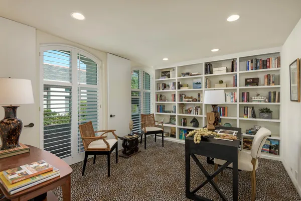 a workspace with furniture and a bookshelf