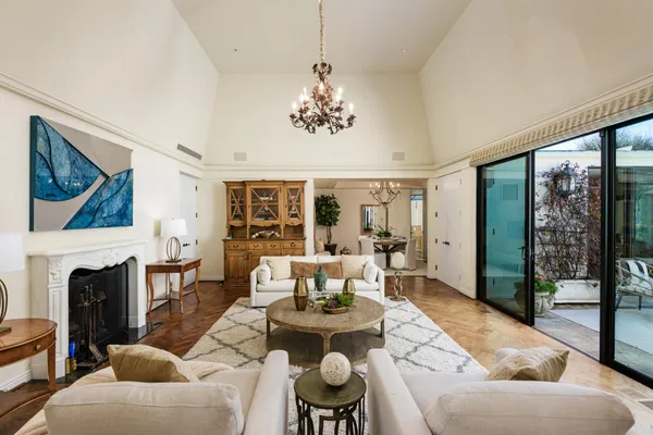 a living room with furniture a fireplace and a large window