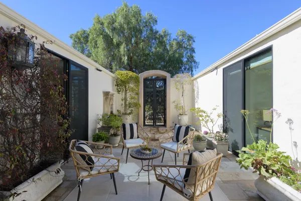 a view of a patio with couple of chairs and a fire pit