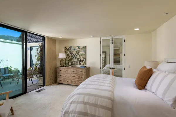 a bedroom with a large bed and a window