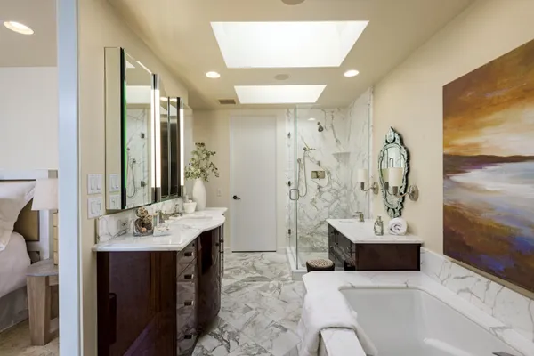 a bathroom with a tub sink and mirror